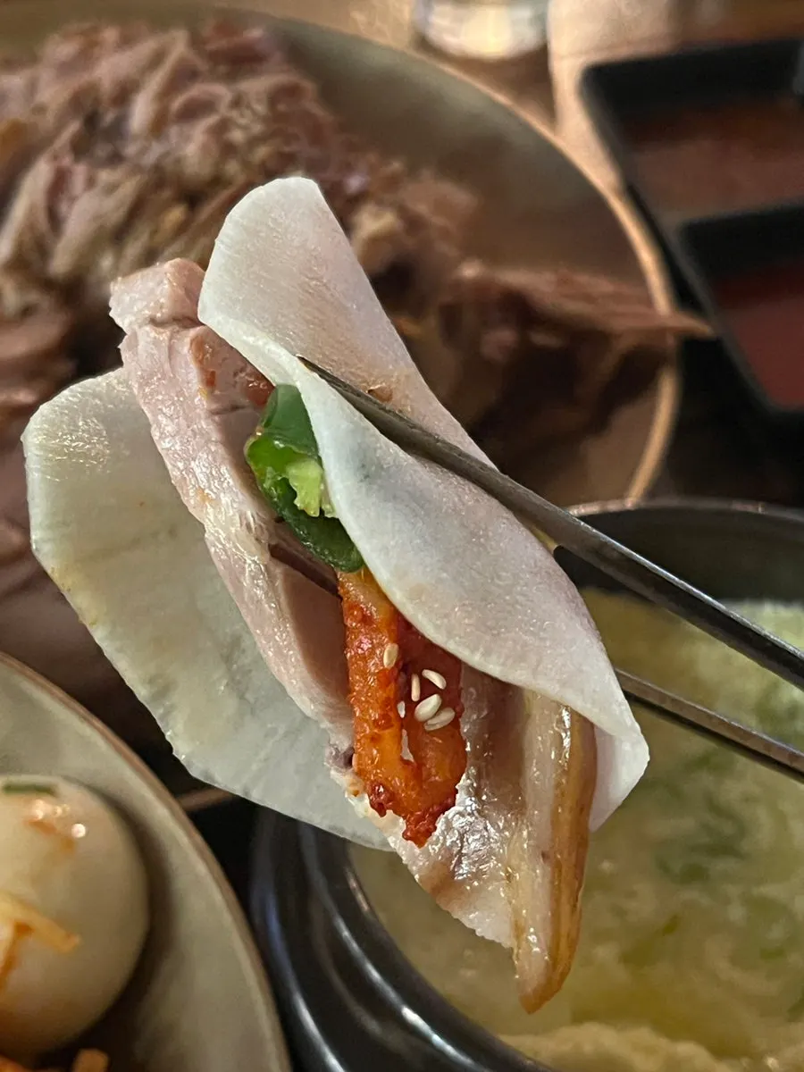 족발 쌈을 들고 있는 모습