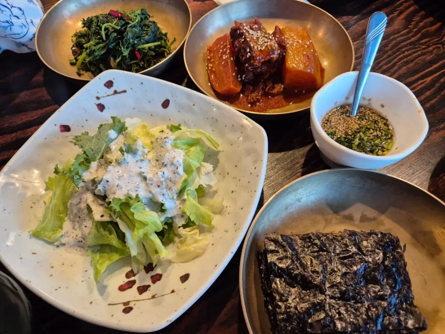 Plates of the many banchan (side dishes) in the set menu