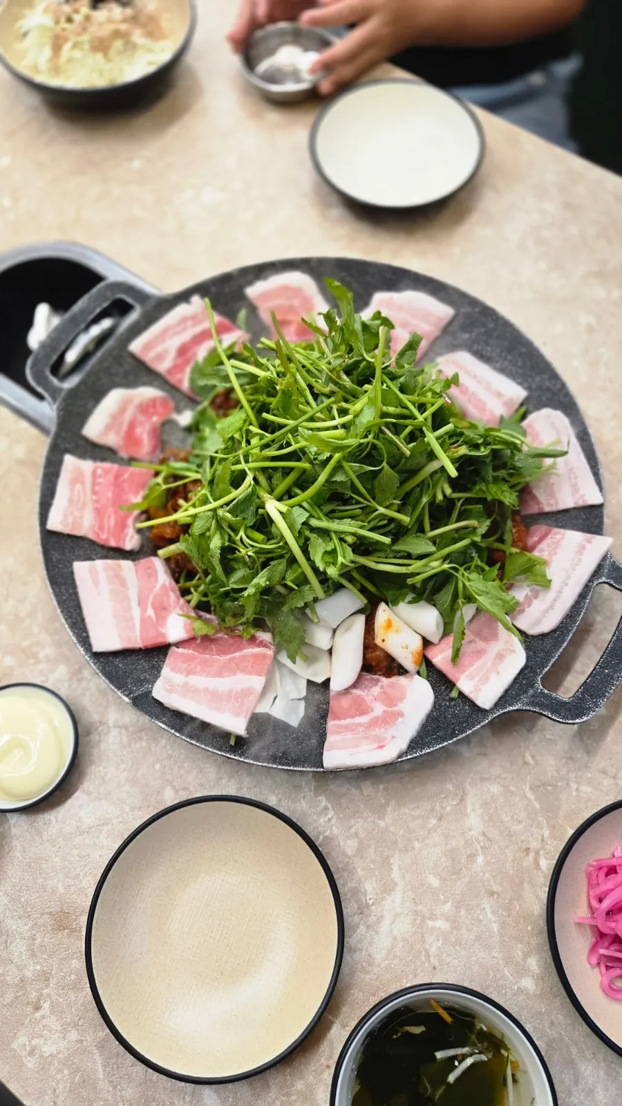 Jjukkumi and black pork belly stir-frying on the griddle