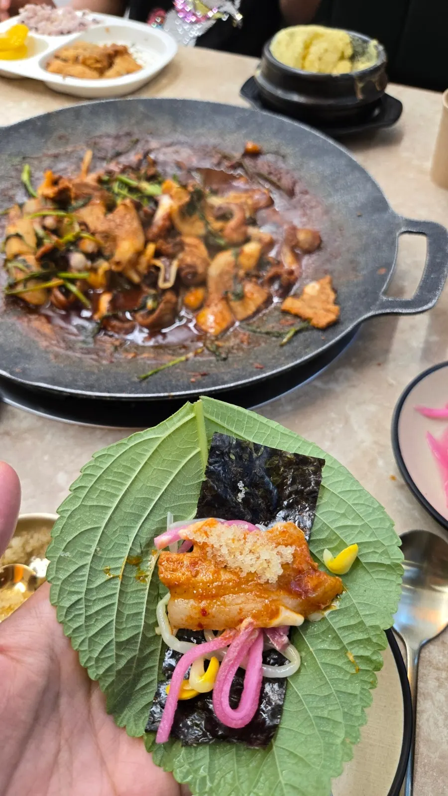A wrap of jjukkumi in a perilla leaf