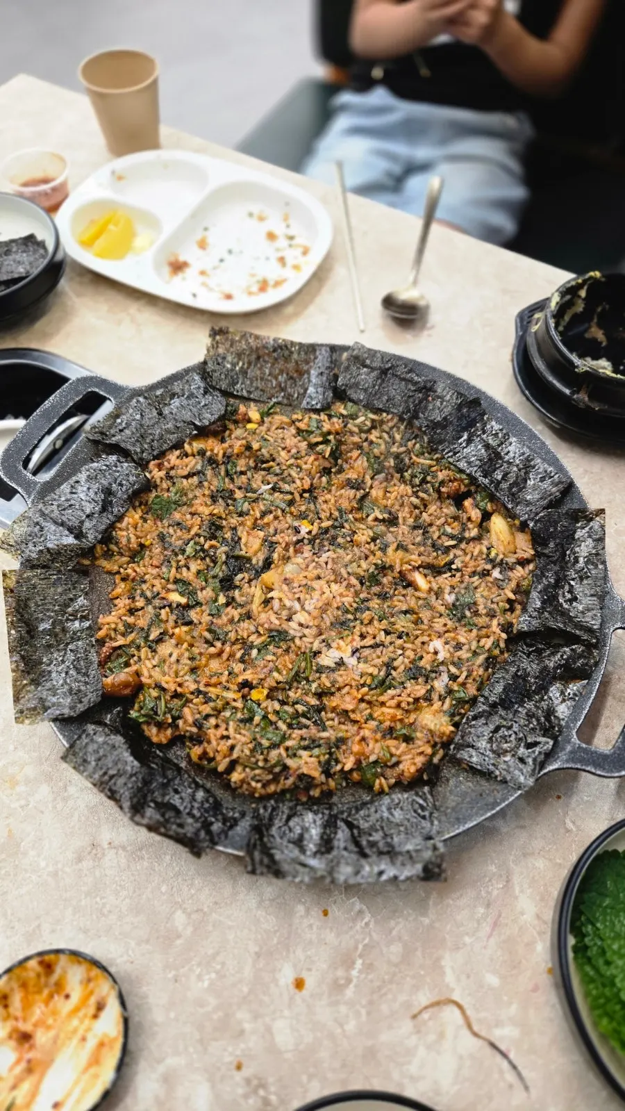 Fried rice with seaweed lining the edge of the griddle