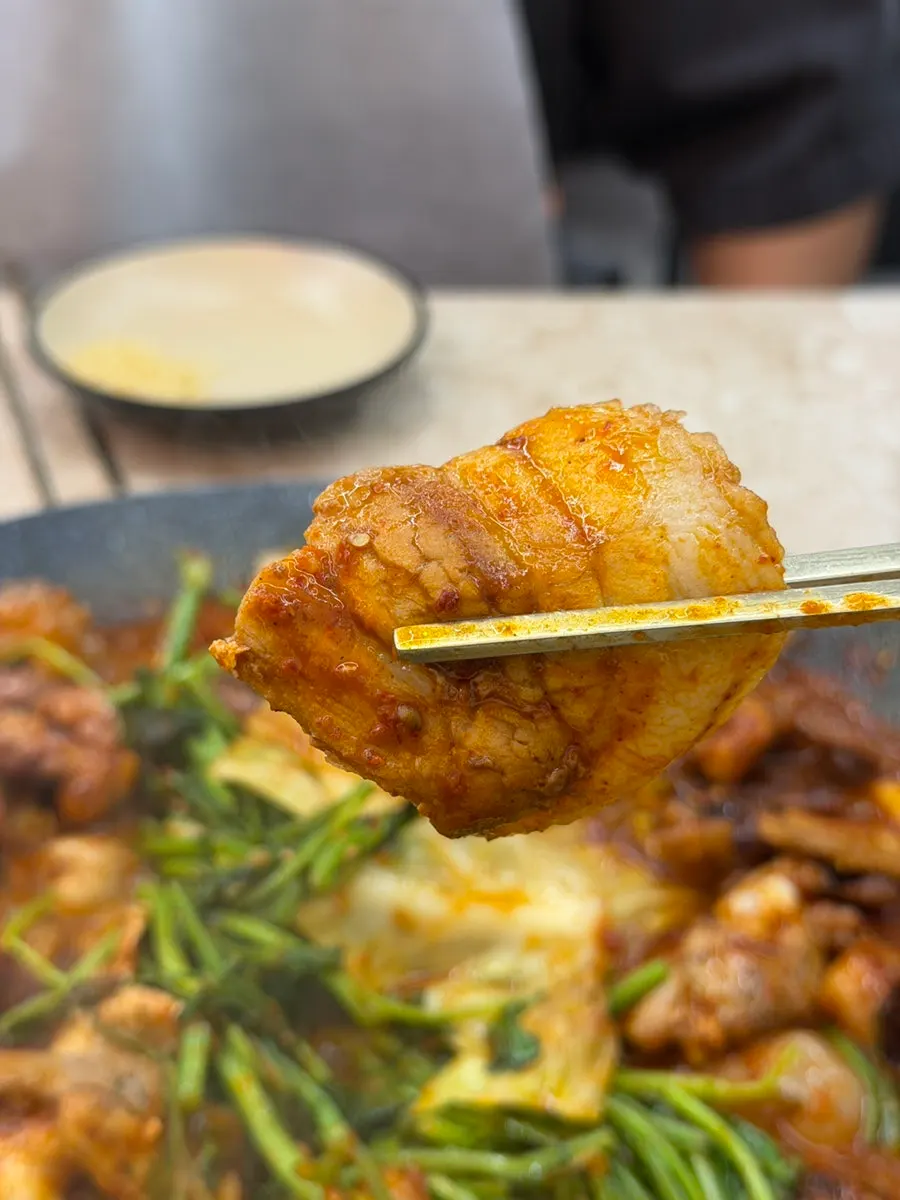 A ladle of the spicy jjukkumi stir-fry