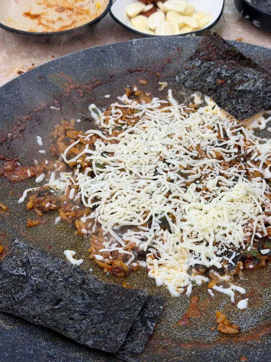 Jjukkumi fried rice topped with snow cheese