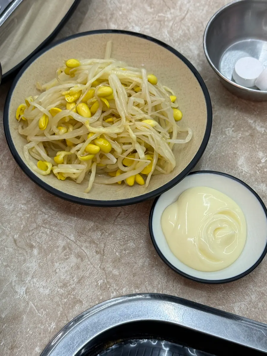 Basic side dishes of bean sprouts, julienned radish, seaweed, and perilla leaves