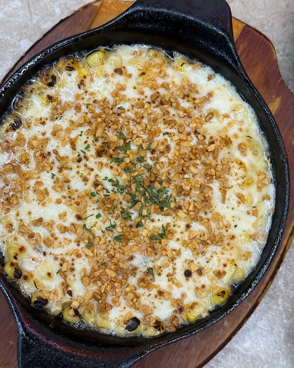 Corn cheese stretching long when scooped with a spoon