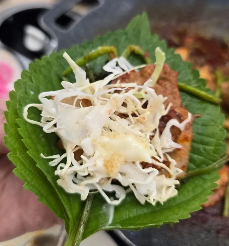 Jjukkumi and pork belly wrapped in a sesame leaf