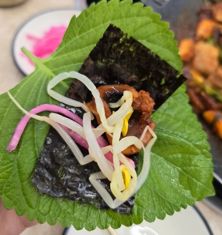 Sesame leaf wrap topped with flying fish roe and bean sprouts