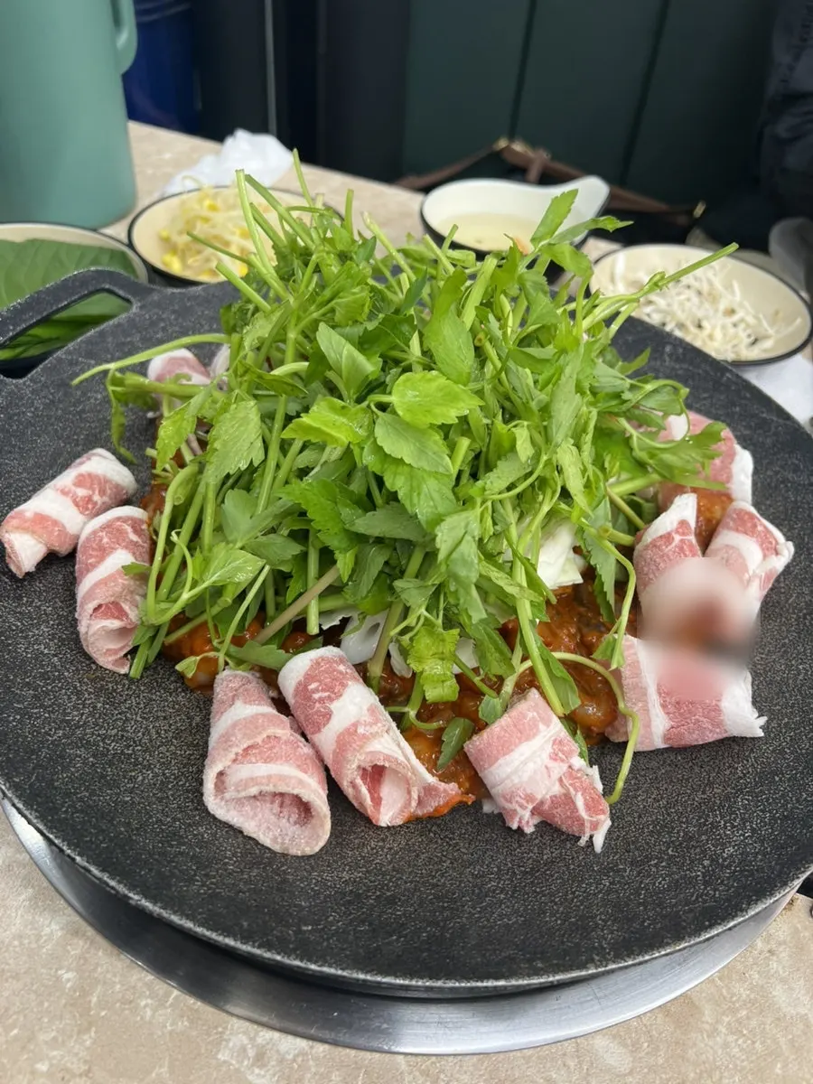 Griddled jjukkumi topped with plenty of minari