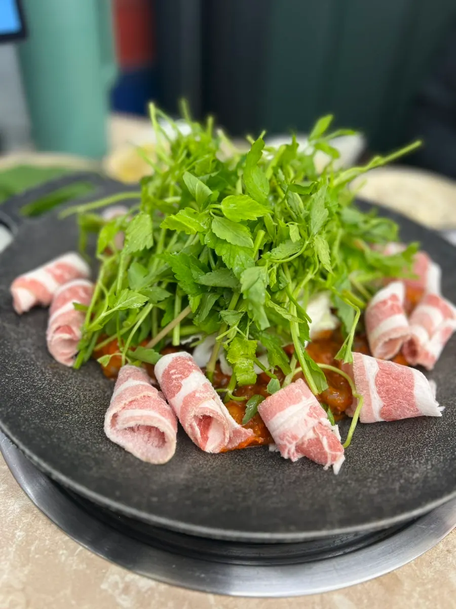 Large raw jjukkumi piled on the griddle