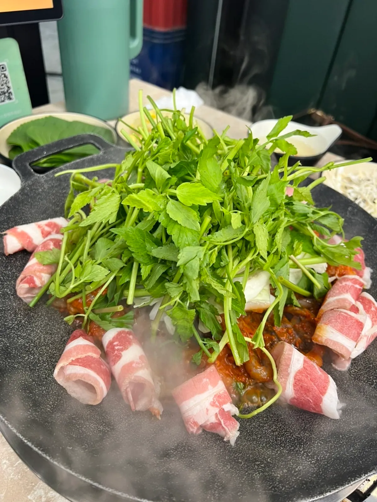 Jjukkumi and beef belly cooking on the griddle