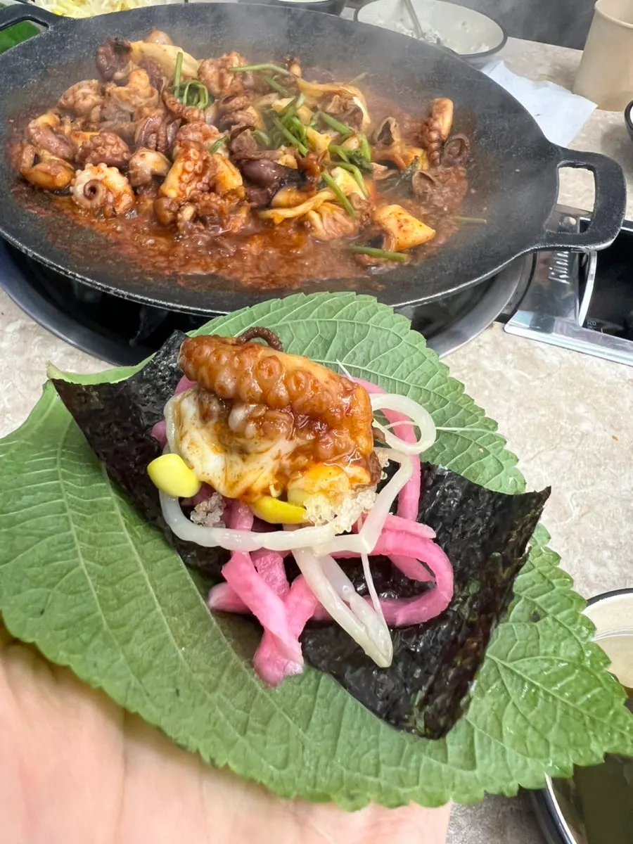 A jjukkumi wrap folded into a single bite
