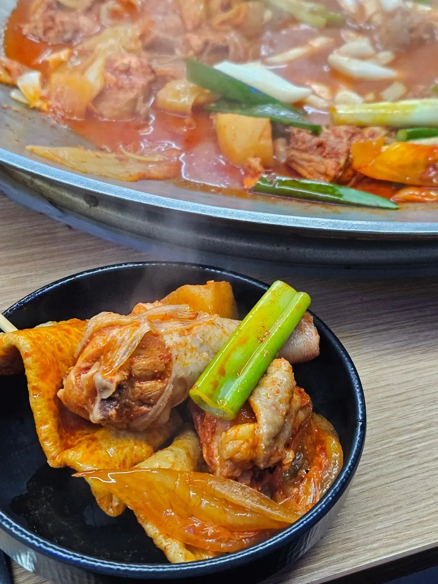 A full spread of aged-kimchi lid chicken stew