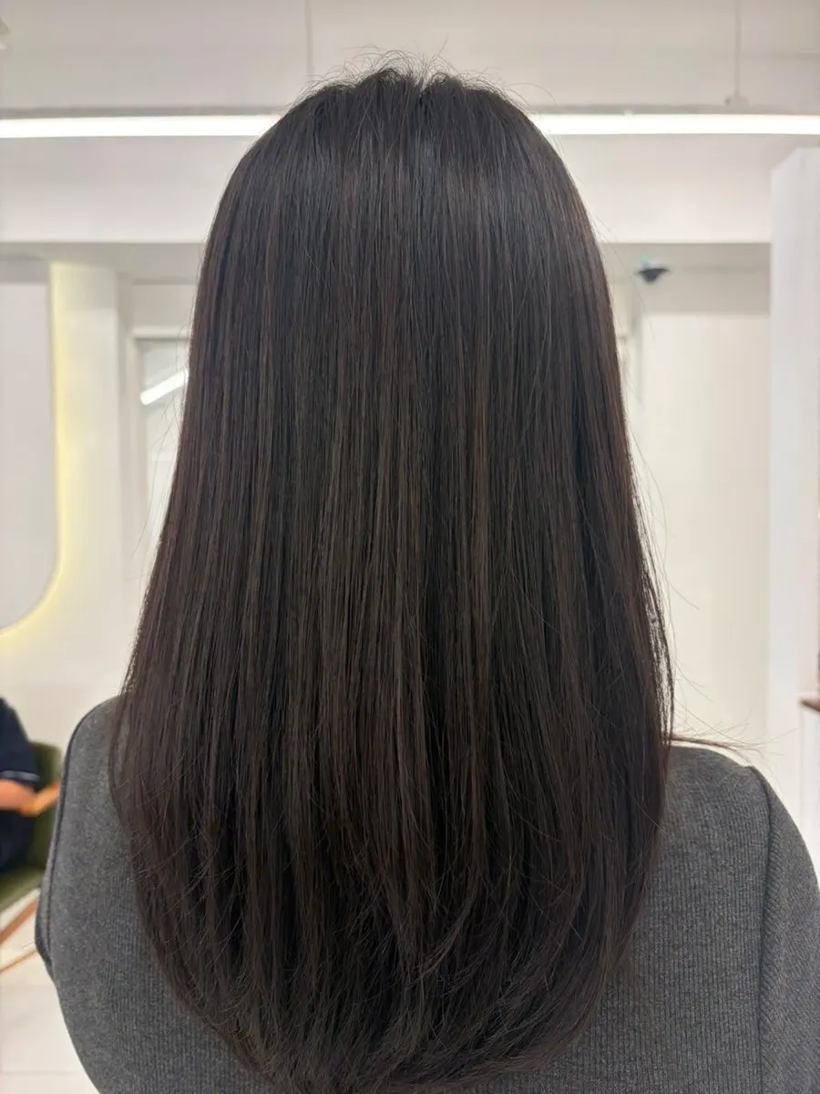 Front view after finishing the layered cut and root perm