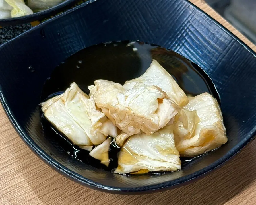 Basic side dish spread with cabbage and white kimchi
