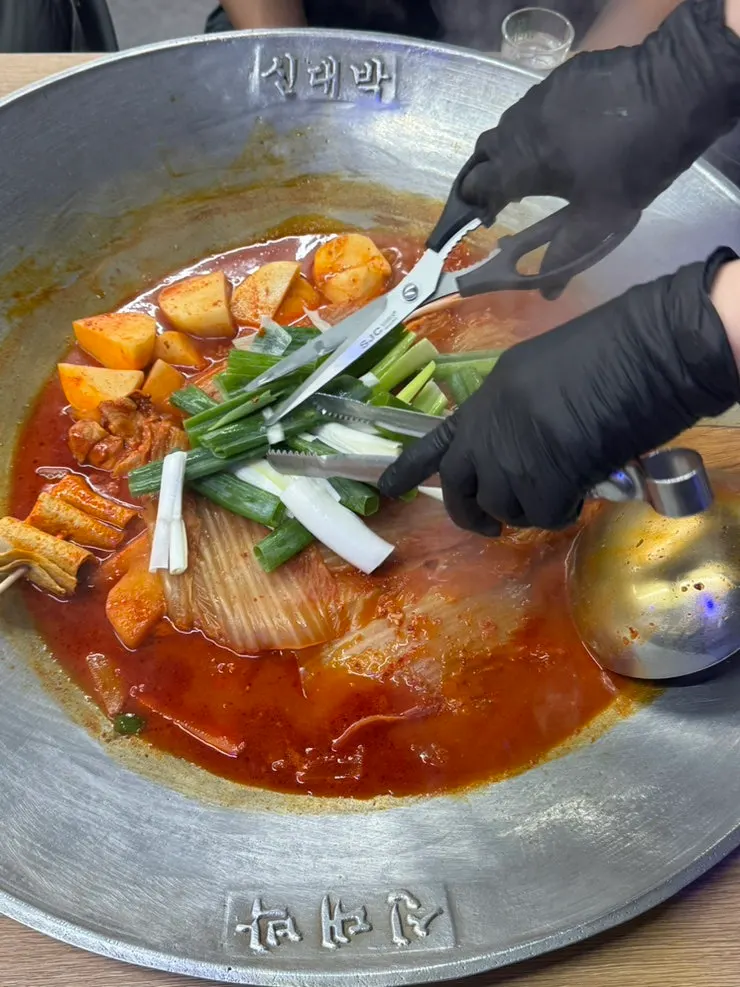 Chicken stew being cooked in a corner of the restaurant timed to the reservation
