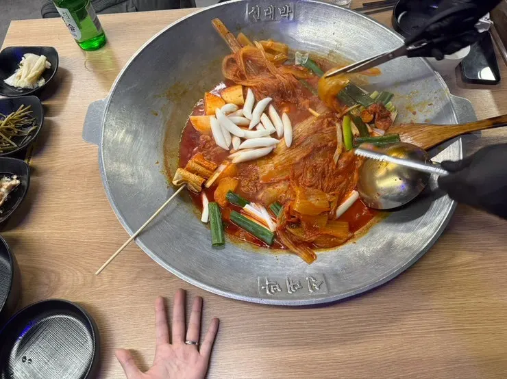 Aged-kimchi cast-iron lid dakdoritang with a whole head of kimchi on top