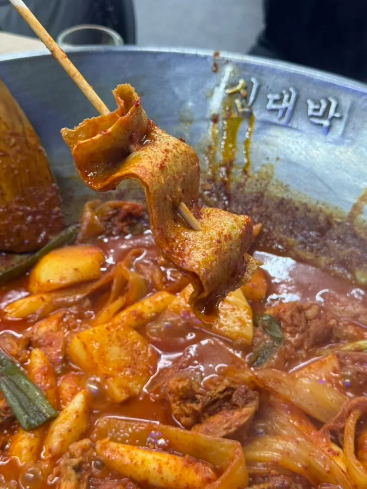 Chicken wrapped in aged kimchi, plated in bite-sized portions