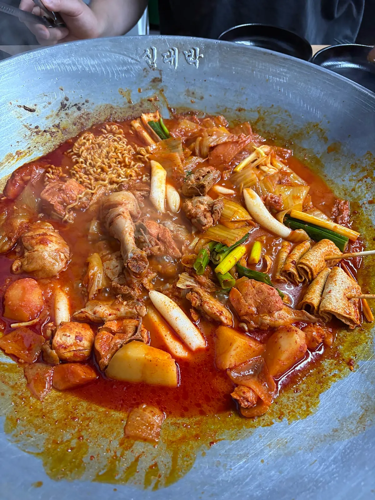 Close-up of aged-kimchi cast-iron chicken stew with a day-aged sauce