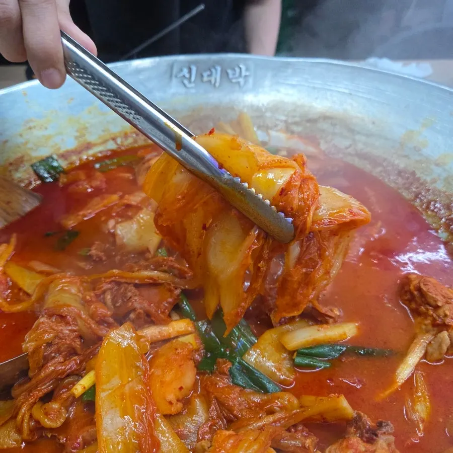 Well-cooked potatoes and aged kimchi in the chicken stew