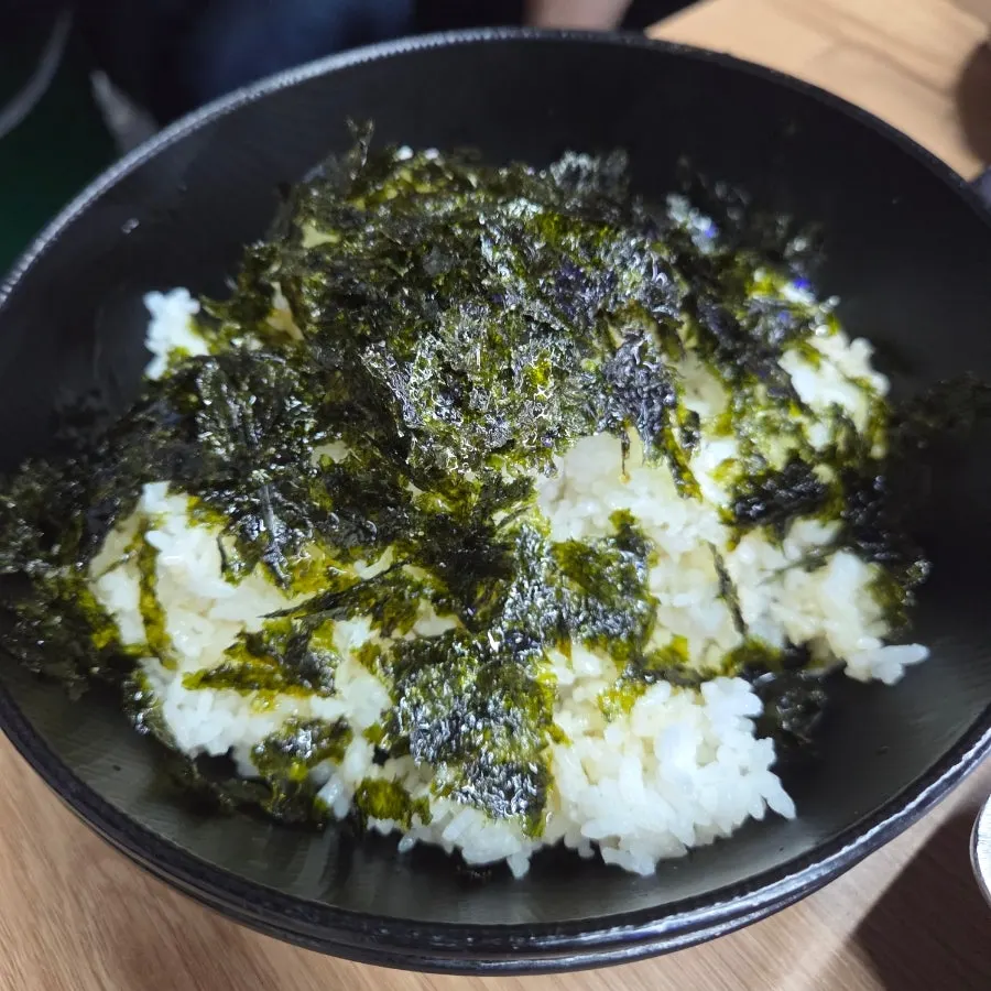 Self-fried rice being cooked in the cast-iron pot lid