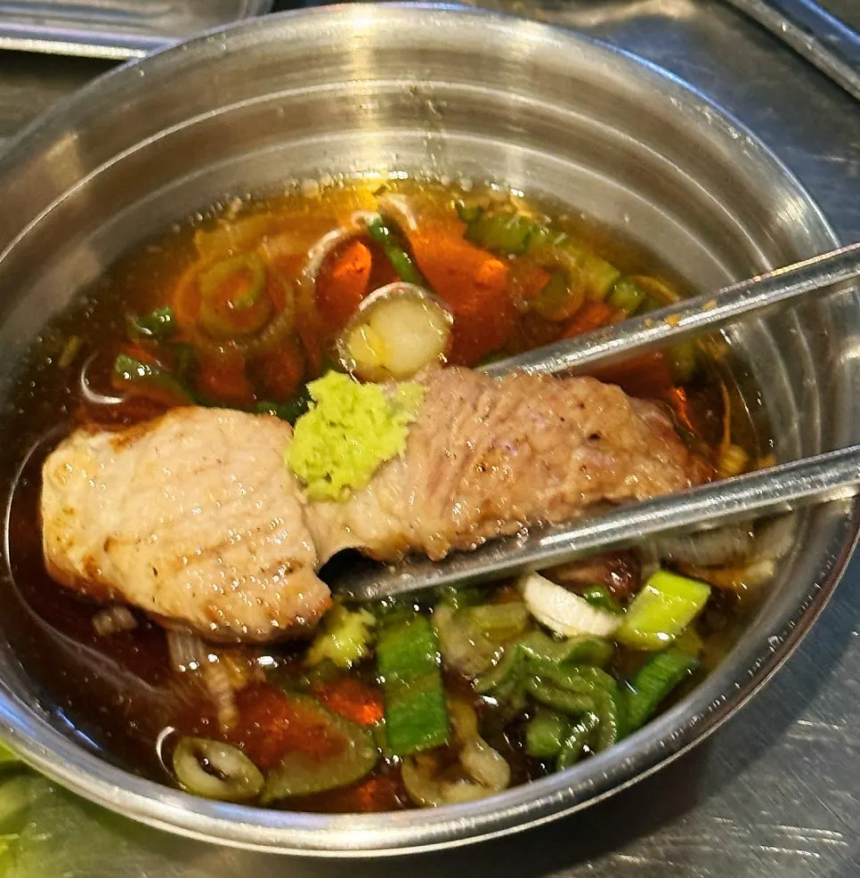 A piece of meat topped with wasabi