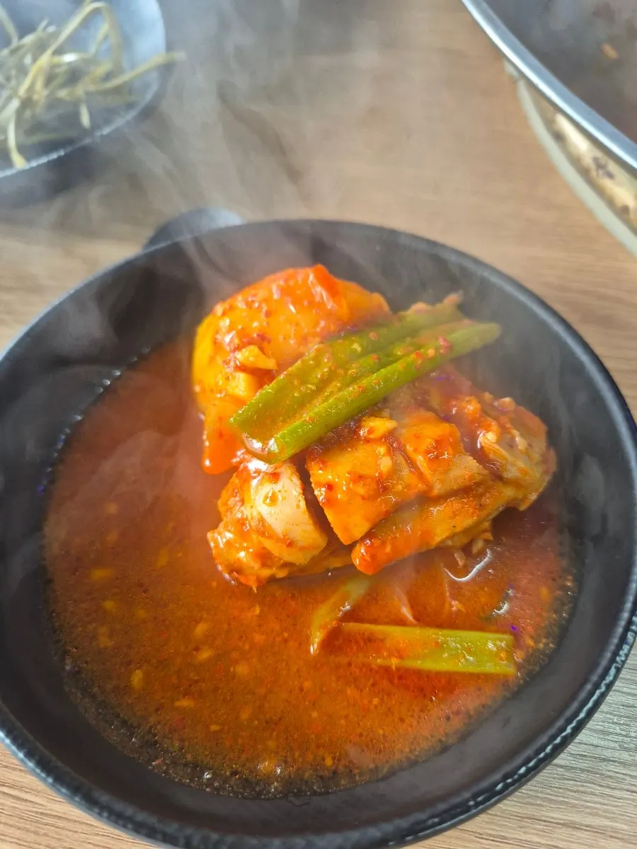 Chicken meat in the reduced, thickened stew broth