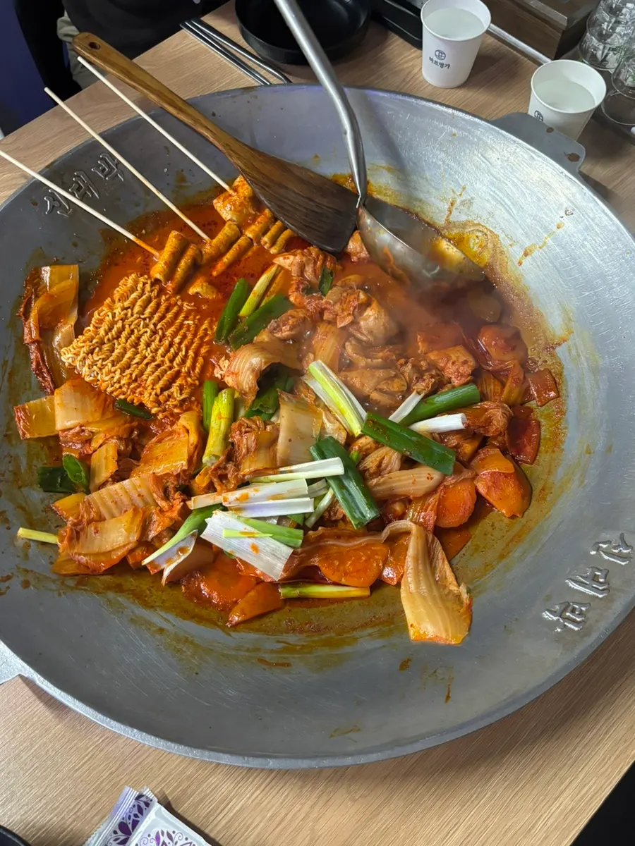 Chicken and aged kimchi on the cast-iron pot lid