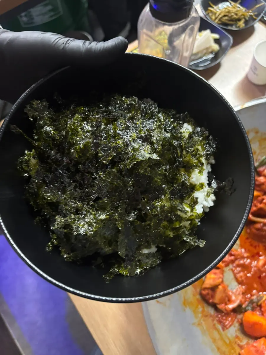 Close-up of reduced sauce coating chicken and aged kimchi