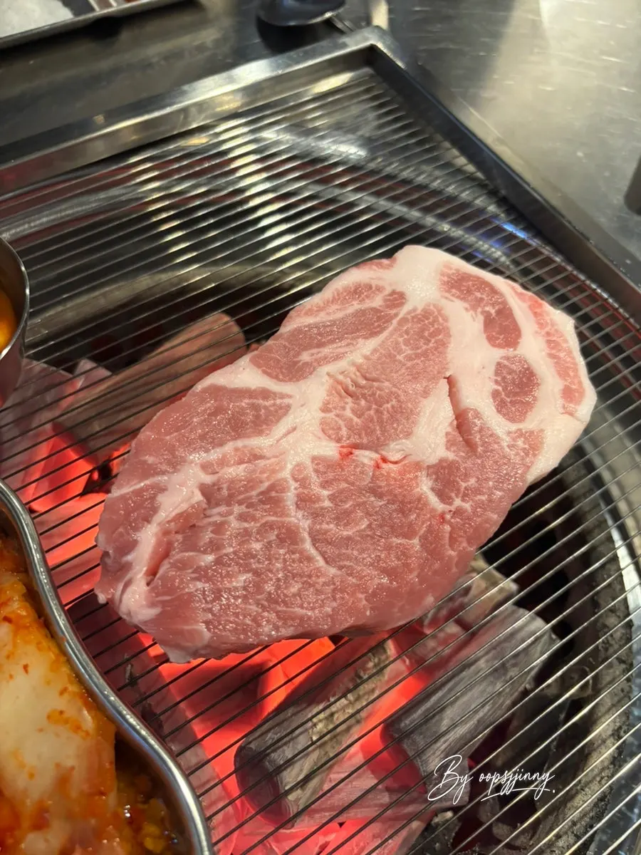 Staff grilling teukmoksal over charcoal