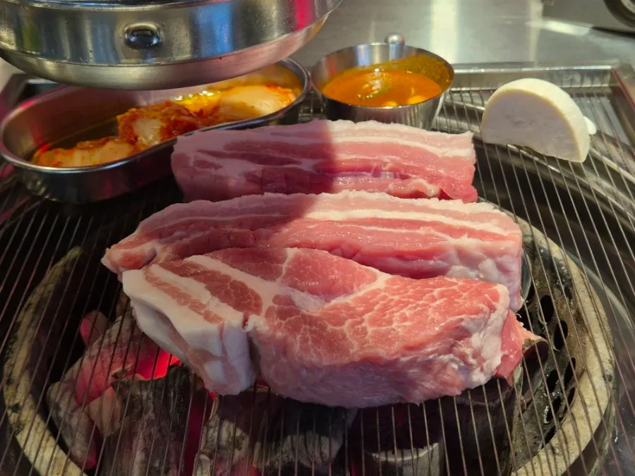 Plate of bright red, thick-cut pork belly and neck