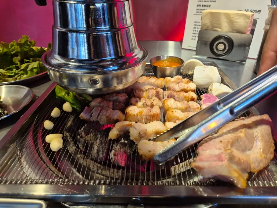 Pork neck and belly grilling to a golden brown