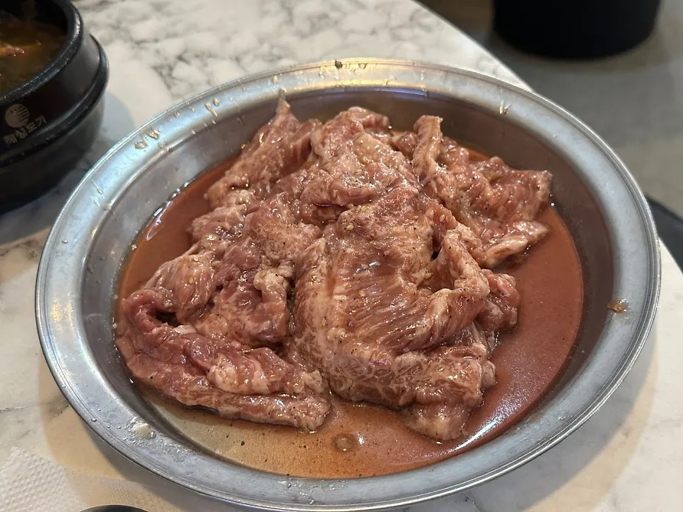 Seoseo Galbi grilling over charcoal