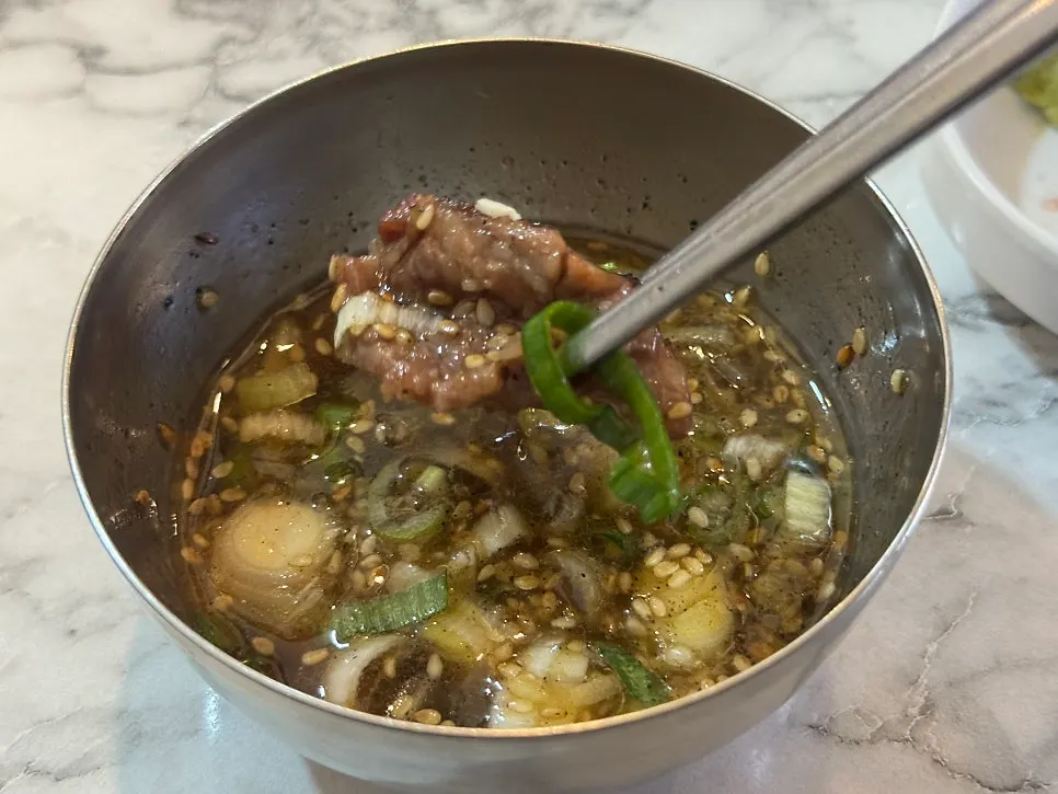 Hand-sliced seoseo galbi being grilled