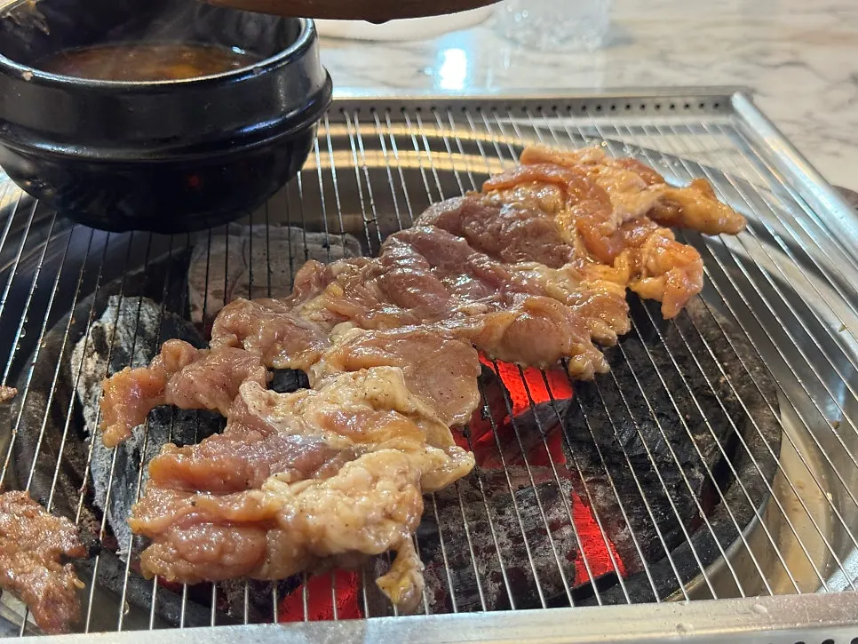 A piece of seoseo galbi dipped in the special sauce