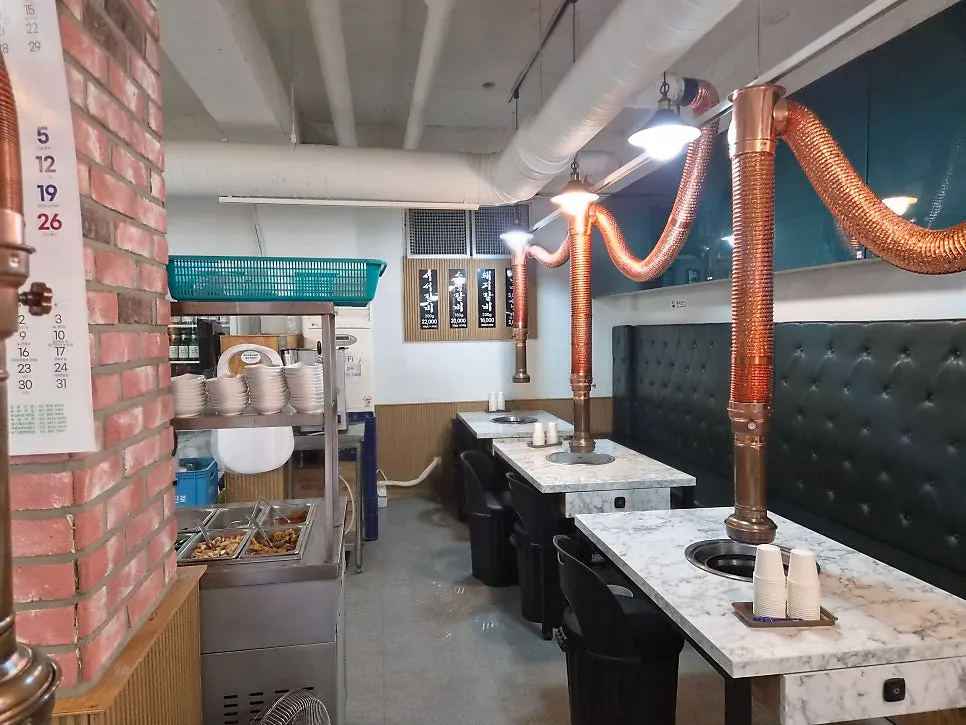 Dining room with tables and exhaust hoods