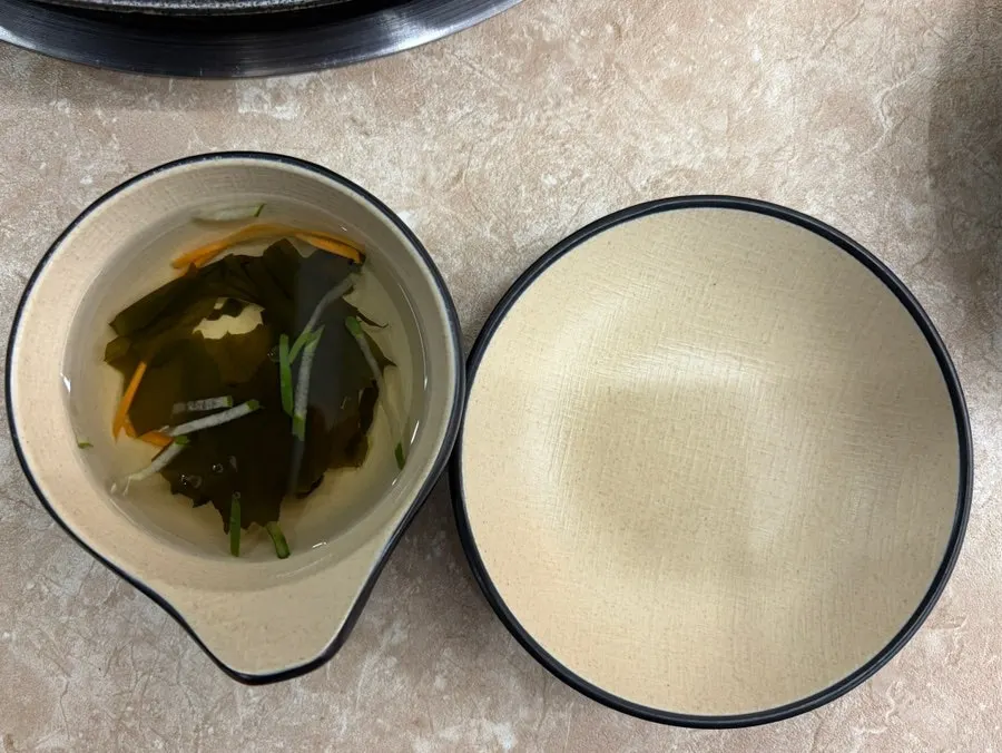 Cold seaweed soup served alongside a salad