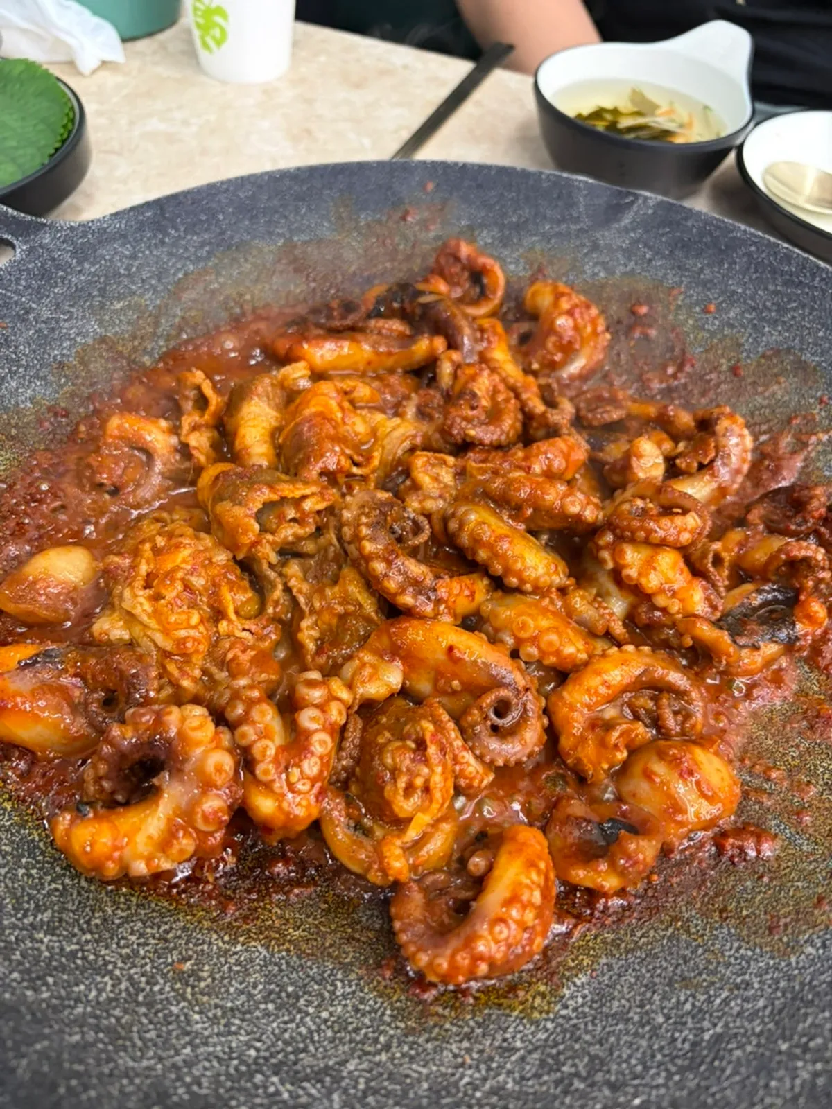 Jjukkumi and beef belly being stir-fried on the griddle