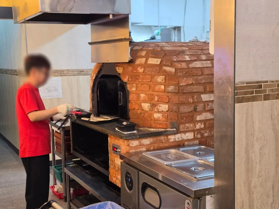 The wood-fired oven inside the restaurant where the fish is grilled