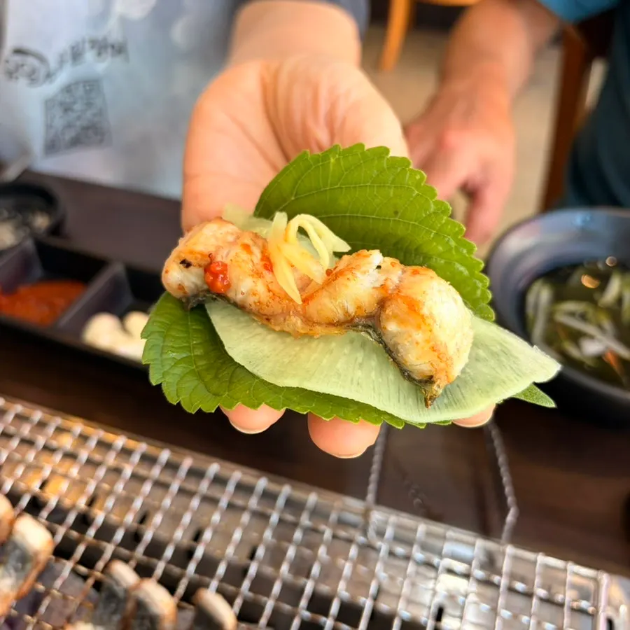 Eel wrap topped with green onion kimchi and ginger
