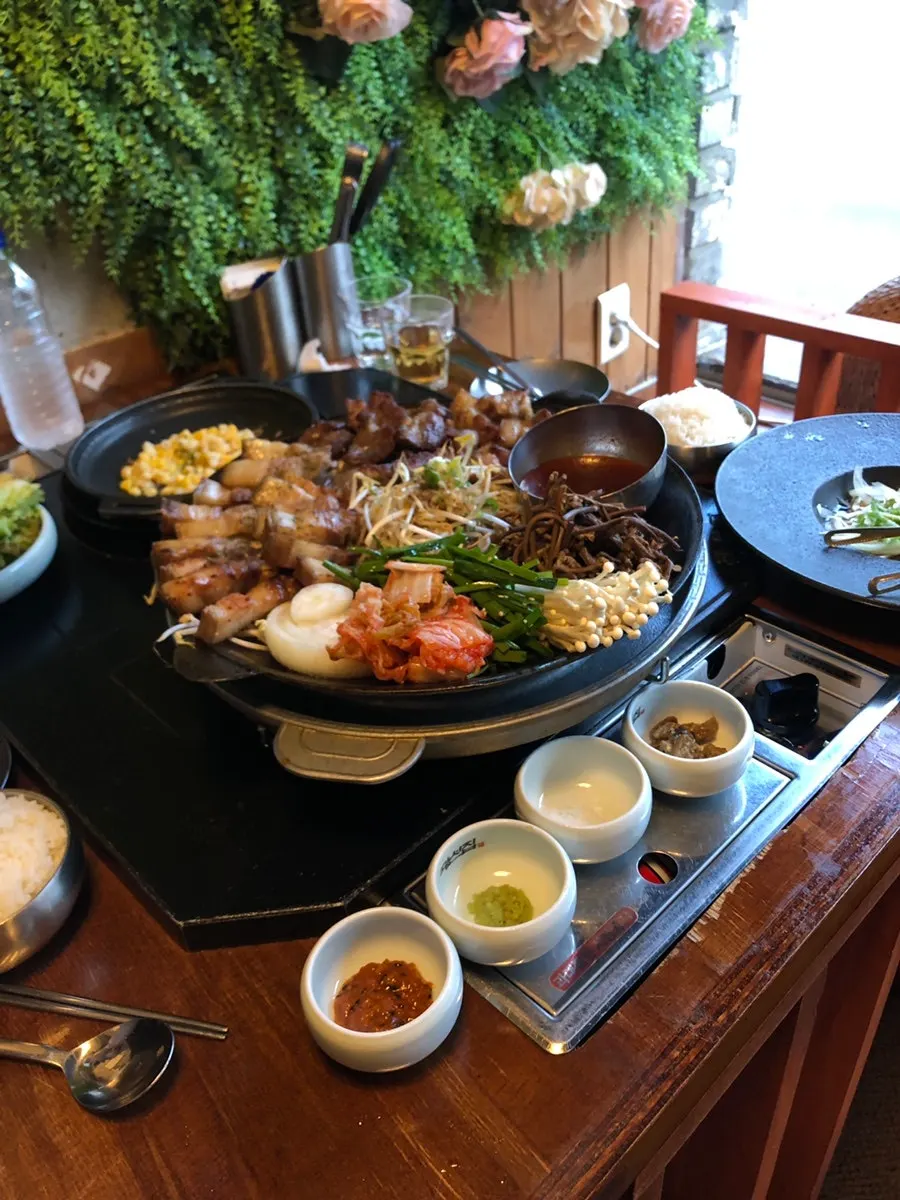 Grilled meat platter topped with chives and kimchi