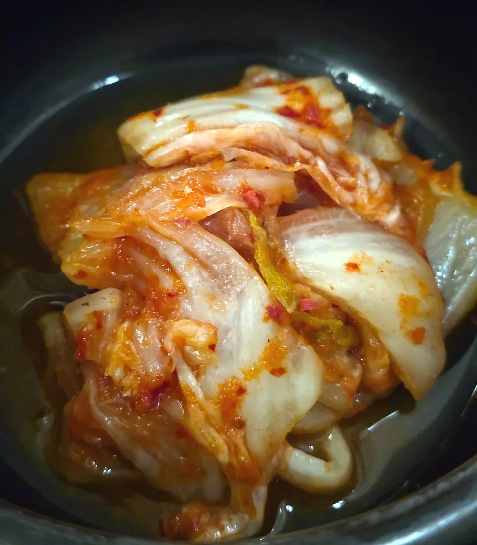 Chives and kimchi added on top of the charcoal grill