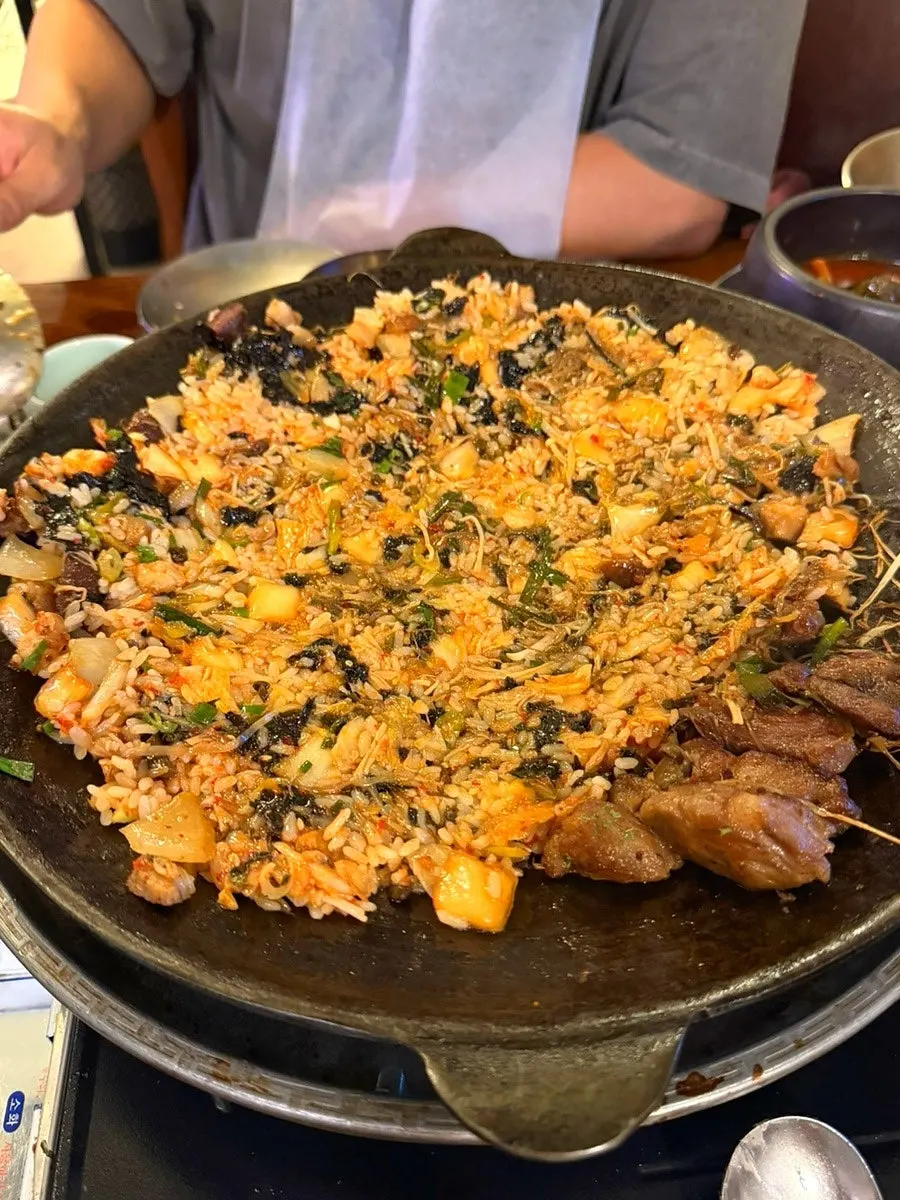 Kimchi and seaweed flake fried rice ingredients on the pan