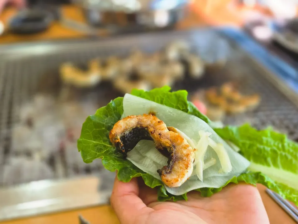 Freshwater eel grilling over charcoal