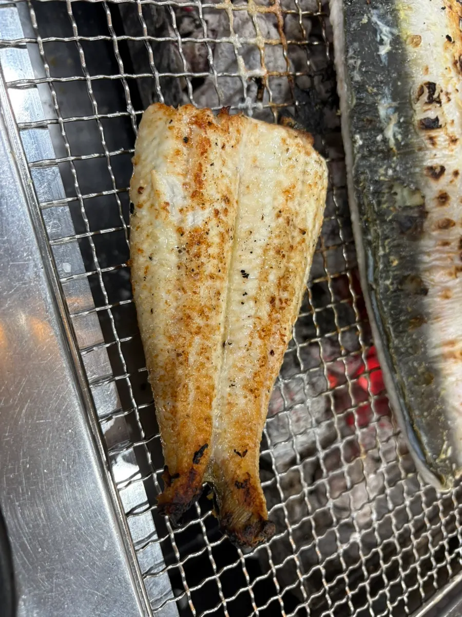 Eel turning golden brown on the charcoal grill