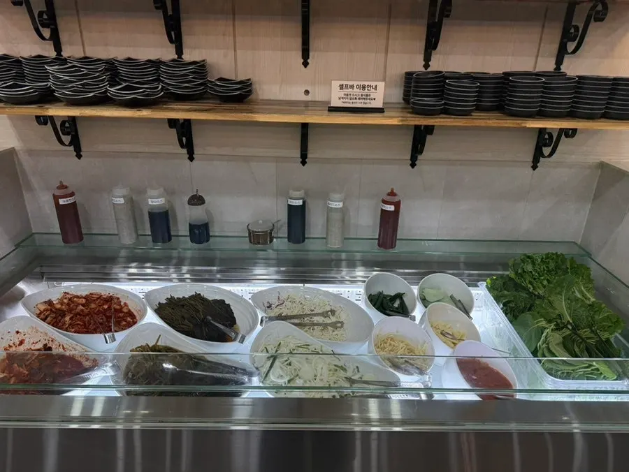Self-serve bar with side dishes and wrap vegetables