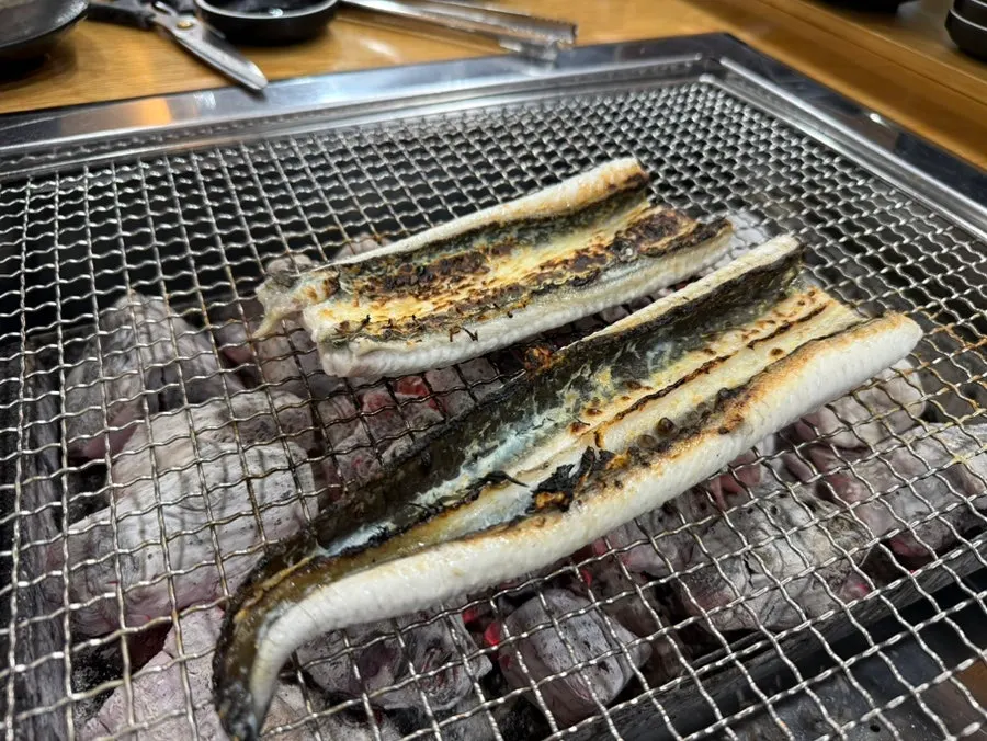 Whole eel placed on the large grill