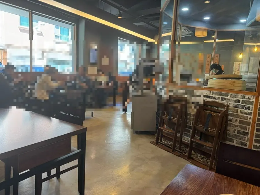 Wood-toned interior seating at Yongja 1 Gwanpyeong Branch