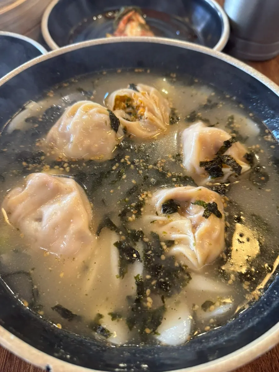 Kimchi dumpling dipped in soy sauce