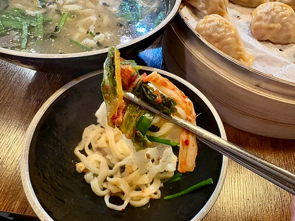 A large steamed dumpling that is hard to eat in one bite