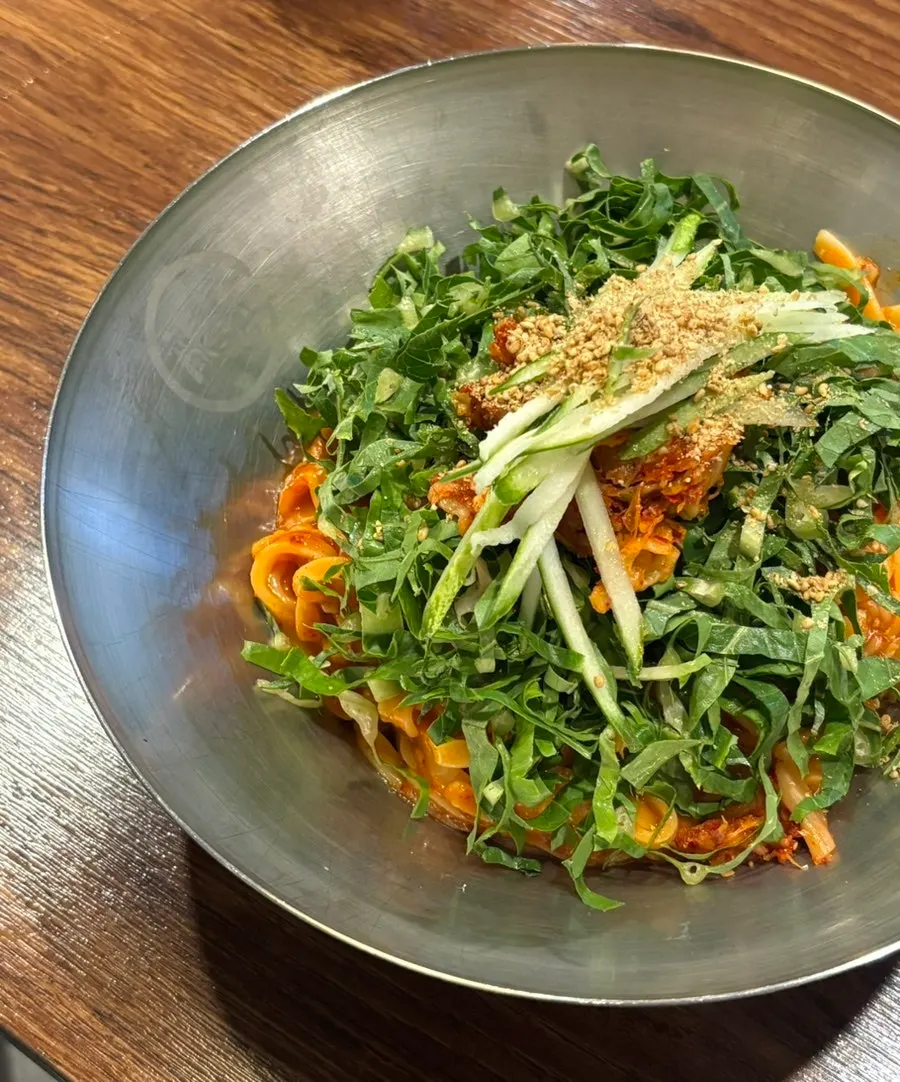 Bibim kalguksu topped with perilla leaf